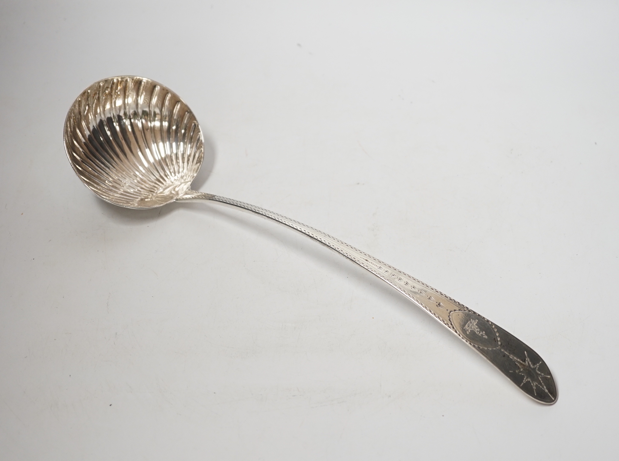 A George III Irish engraved silver soup ladle, John Shiels?, Dublin, 1793, 36cm, with fluted bowl